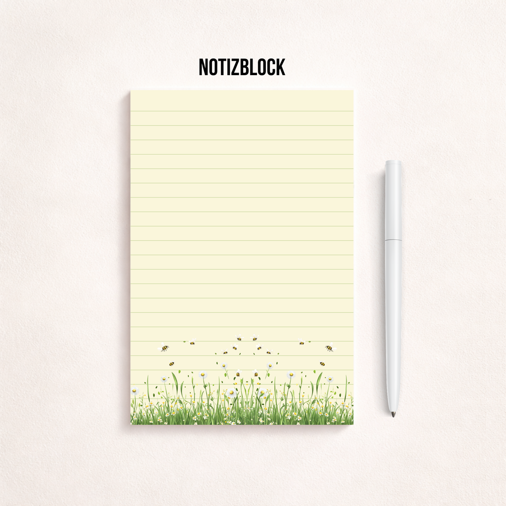 Schmaler, linierter Notizblock im Hochformat mit cremefarbenem Papier, feinen Linien und einer Blumenwiese mit kleinen Bienen am unteren Rand