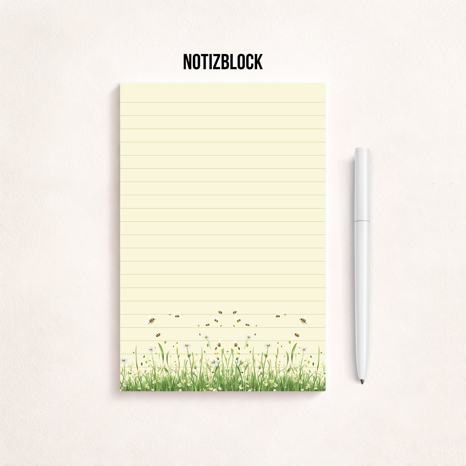 Schmaler, linierter Notizblock im Hochformat mit cremefarbenem Papier, feinen Linien und einer Blumenwiese mit kleinen Bienen am unteren Rand