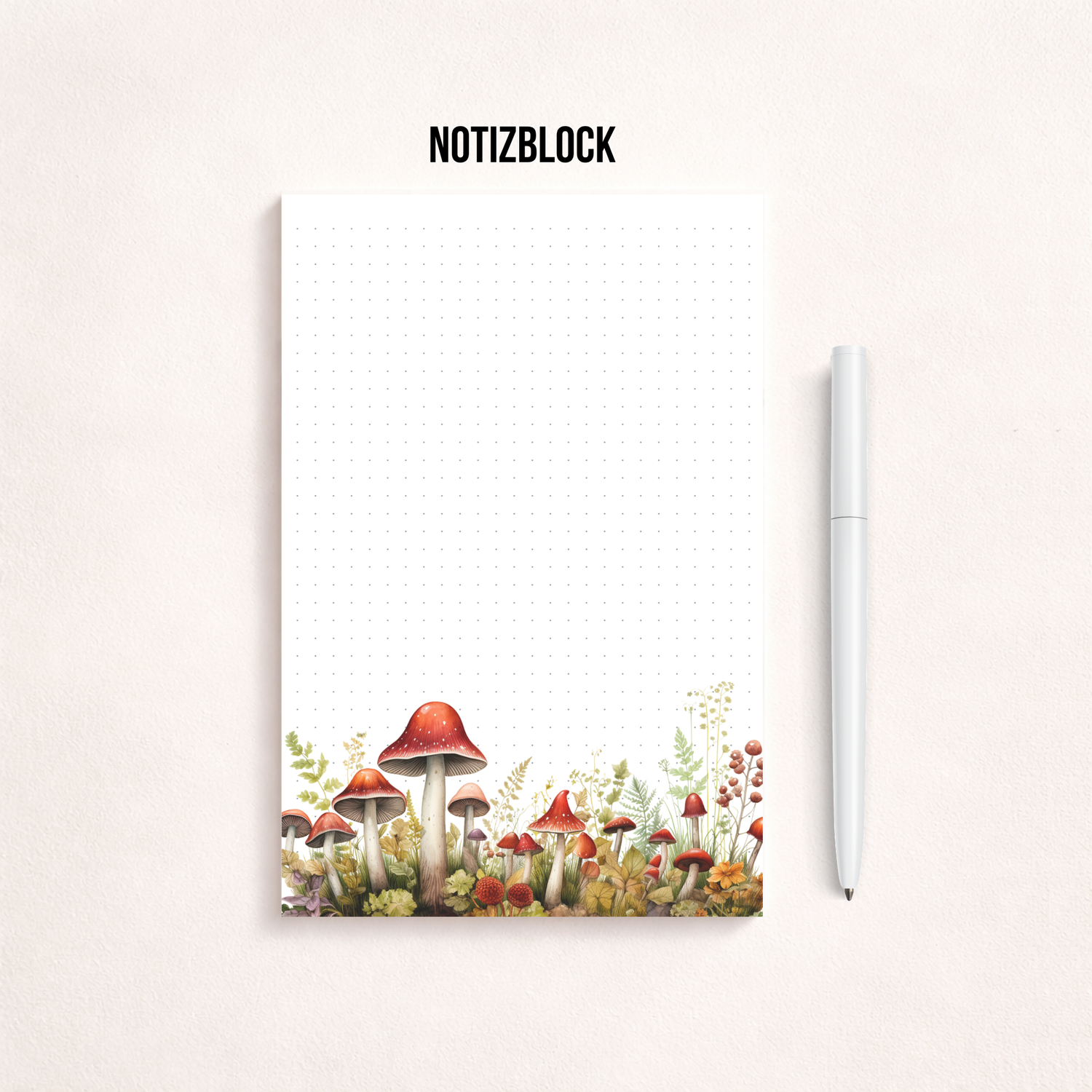 Weißes Notizblatt im Hochformat mit feinem Punktgitter und einer zarten Aquarell-Bordüre aus roten Pilzen, Blumen und Gräsern am unteren Rand